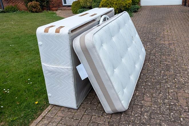 mattress being loaded onto a trailer